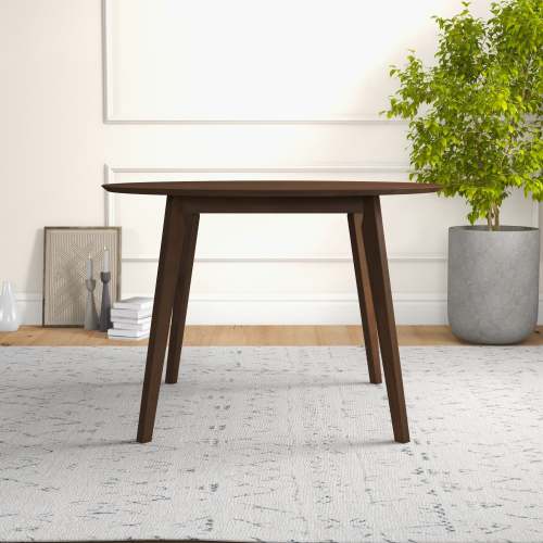 Lara MCM Solid Walnut Round Dining Table 43" – Modern Wood Dining Table in a warm, inviting setting with plants.