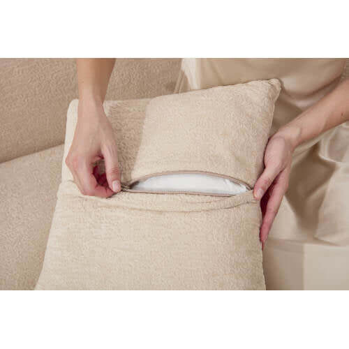Person removing pillow cover of the Boneless Modular Chenille Sectional Sofa – 99” Curved Chaise Compression Couch (White).