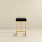 Joel Gold Velvet Bar Stool – Upholstered Backless Counter Stool with Metal Frame (Modern Glam Style) on a neutral background.