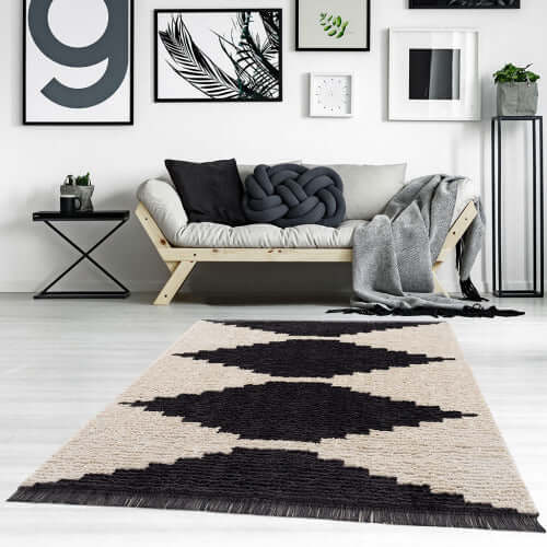 Black & Ivory modern diamond design area rug in stylish living room with cozy furnishings.