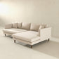 The Blake Velvet Upholstered L-Shape Chaise Sofa Sectional 107 by Ashcroft Furniture, featuring plush velvet and reversible chaise design on wooden legs, adds modern style to a minimalistic room with light walls and floors.