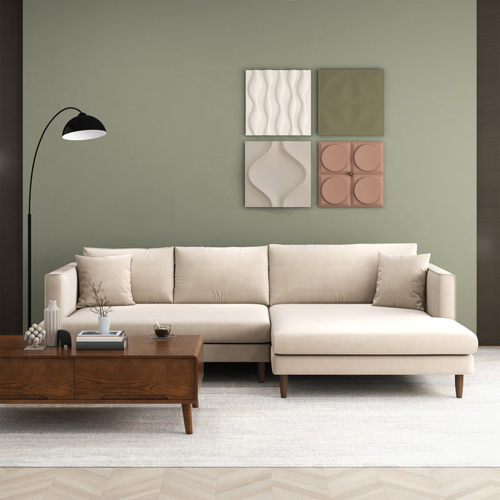 A modern living room with the Ashcroft Furniture Blake Velvet Upholstered L-Shape Chaise Sofa Sectional 107, a wooden coffee table, black floor lamp, four textured wall art panels on a green wall, light rug, and minimalistic decor for modern elegance.