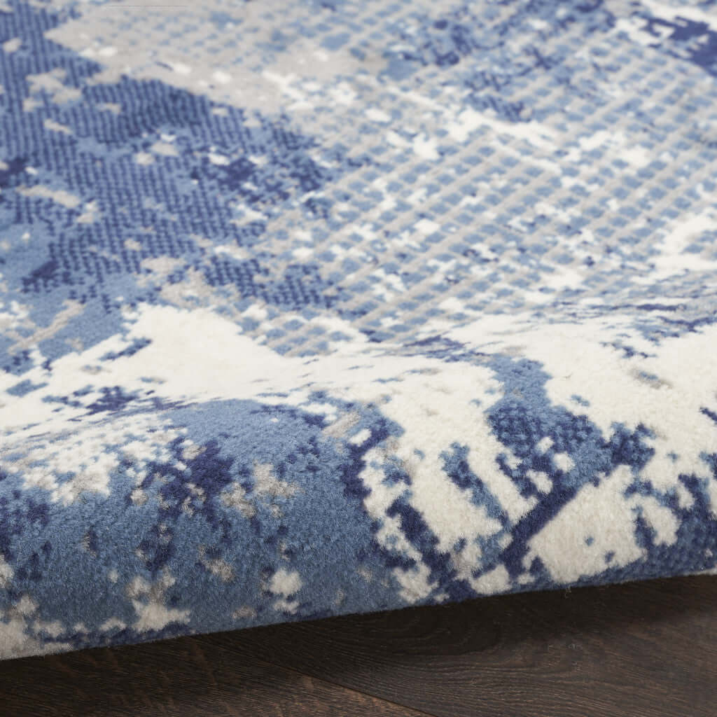Close-up of a Blue Abstract Power Loom Runner Rug showcasing an intricate design in shades of blue and cream.