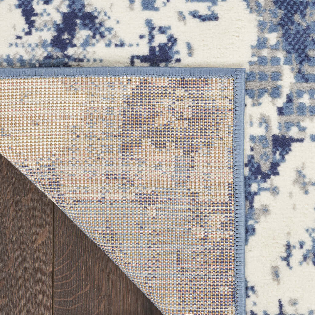 Corner close-up of Blue Abstract Power Loom Runner Rug showing intricate design and durable backing on wooden floor.