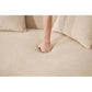 Hand pressing into the soft fabric of the Boneless Modular Chenille Sectional Sofa – 99” Curved Chaise Compression Couch (White)
