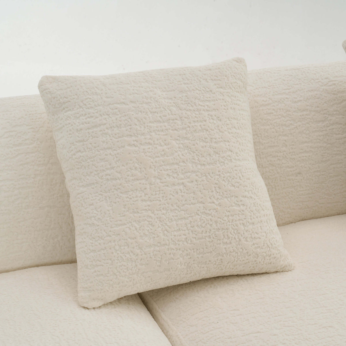 Close-up of a plush pillow on the Boneless Modular Chenille Sectional Sofa – 99” Curved Chaise Compression Couch (White).