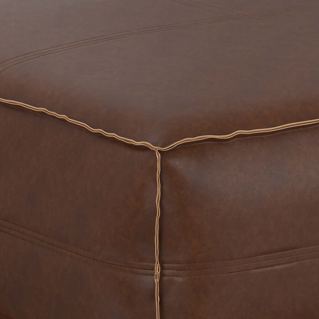 Close-up view of the Brody Large Square Faux Leather Ottoman 36" – Coffee Table Ottoman (2 Colors) in brown faux leather.