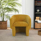 Wichita Chenille Lounge Chair – Modern Curved Accent Chair (Brown or Gold) in yellow with palm and bookshelf.