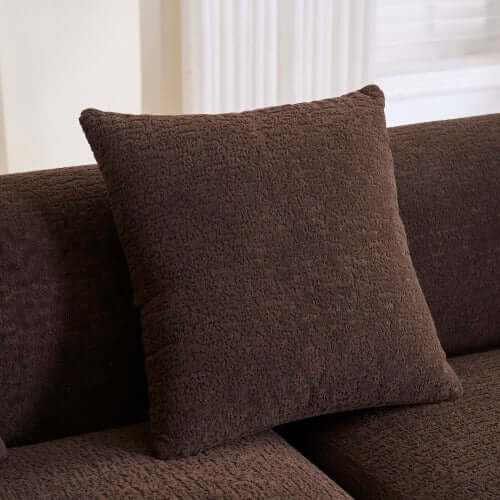 Brown plush pillow on the Boneless Modular Chenille Sectional Sofa – 99” Curved Chaise Compression Couch (White).