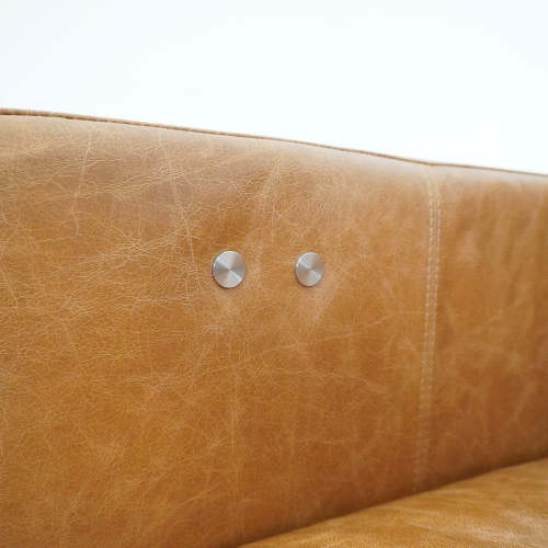 Detail of Christopher MCM Leather Power Reclining Sofa 93" – Mid-Century Modern Recliner Couch showing leather texture and button.