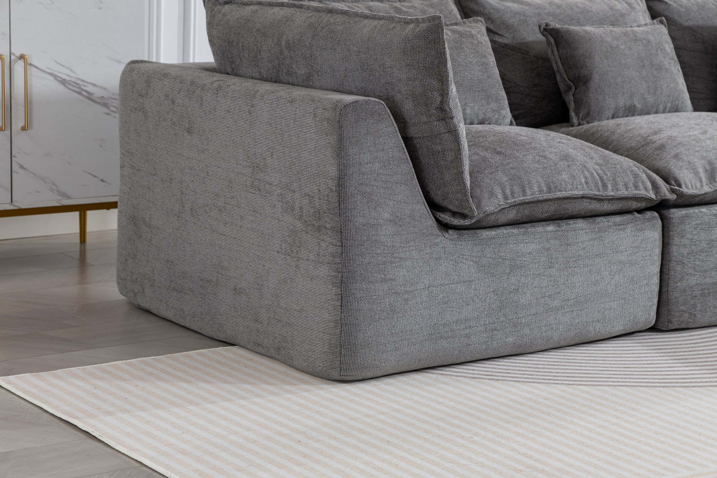 Cloud Oversized Modular Sectional Sofa with Ottoman – 102.3” Velvet Deep Seat Couch corner view on a light rug.