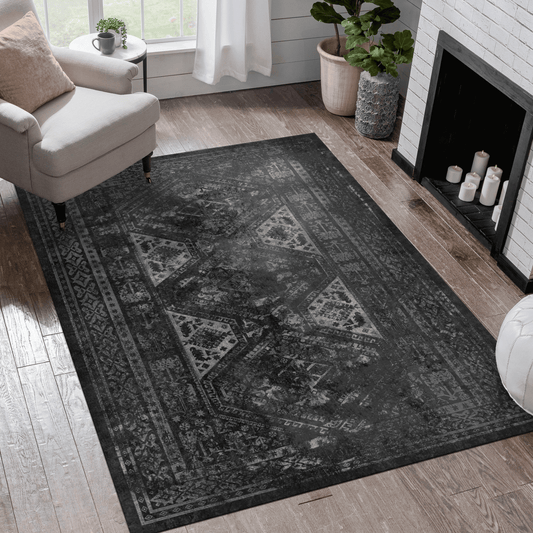Black and gray rectangular area rug in a stylish living room setting with a cozy chair and fireplace.