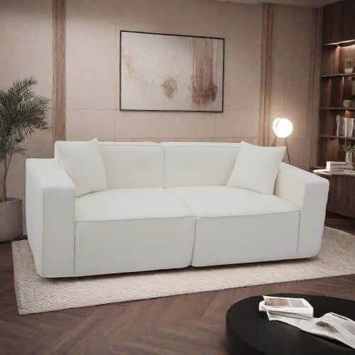 Modern low profile white memory foam sofa with box arms in a stylish living room.