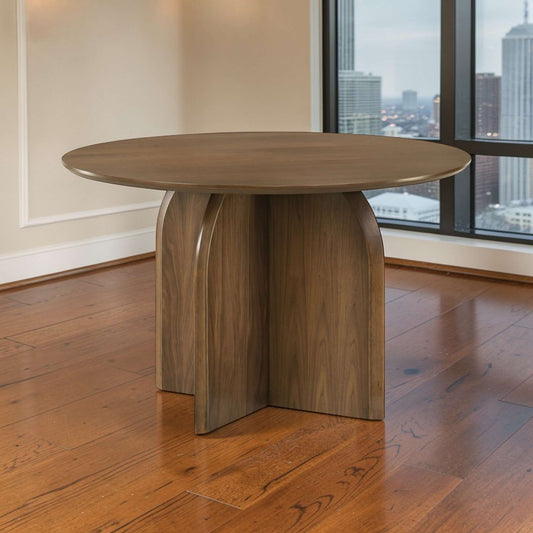 Delmon Dark Walnut Round Dining Table 47" in a modern dining room setting with large windows