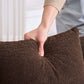 An individual adjusting a plush brown pillow on the Boneless Modular Chenille Sectional Sofa – 99” Curved Chaise Compression Couch (White).