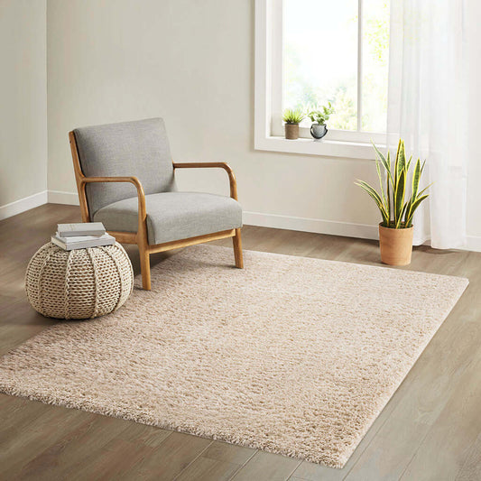 Rectangular polyester shag rug in a cozy living room with a chair and plant, showcasing plush comfort and modern style.