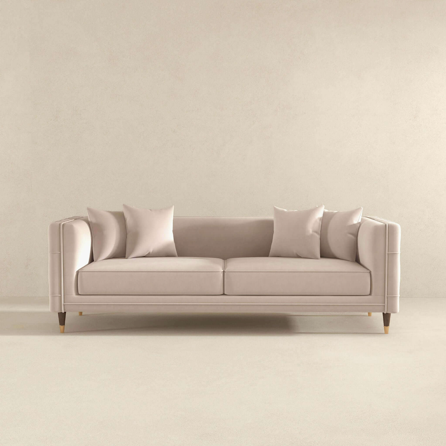 The Ashcroft Furniture Edward MCM Elegant Tufted Velvet Sofa 90 in beige, with four matching cushions, sits against a plain light wall and floor in a minimalist room.