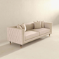The Ashcroft Furniture Edward MCM Elegant Tufted Velvet Sofa 90 features beige velvet upholstery, tufted sides, wooden legs, and four matching throw pillows, perfect for minimalist spaces with light-colored decor.