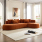 L-shaped chaise sofa sectional in orange fabric with plush cushions, elegantly styled in a modern living room.
