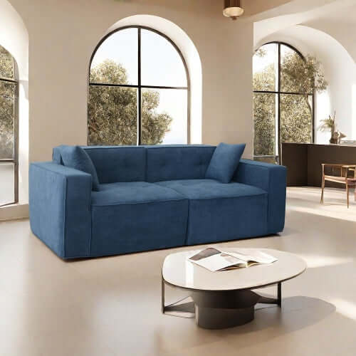 Modern low profile box arm memory foam sofa in blue, showcasing comfort and style in a bright living room.