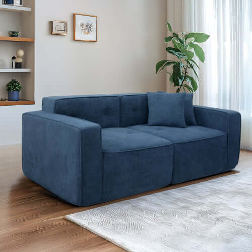 Modern low profile box arm memory foam sofa in dark blue, designed for comfort in contemporary living spaces.