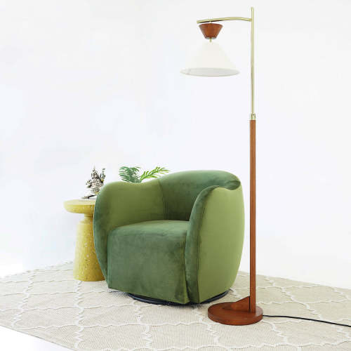 Swivel Lounge Chair in Green Velvet – Renee Modern Barrel Accent Chair beside a stylish floor lamp and side table.