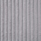Close-up of gray corduroy fabric texture showcasing vertical ridges and plush softness.