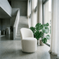 Hollis Beige Boucle Accent Chair (Set of 2) in a modern living space with large windows and greenery.