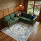 Ivory and Blue Wool Floral Hand Knotted Area Rug With Fringe Area Rug | 9' x 13' under a green sectional sofa in a cozy room.