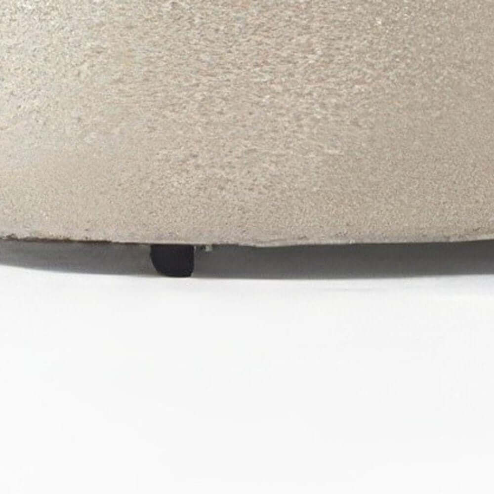 Close-up view of the base of an ivory boucle curved modular sectional sofa showcasing texture and design details.