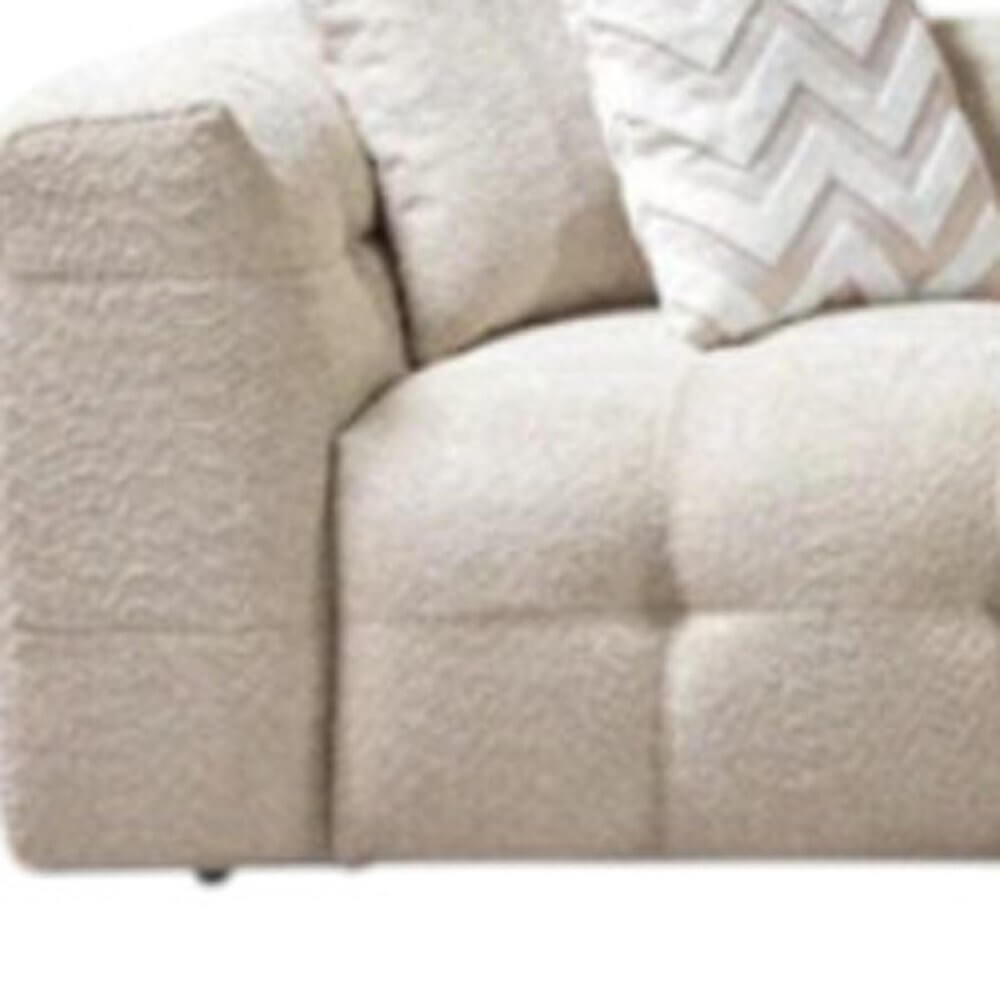 Ivory Boucle L Shaped Two Piece Sofa and Chaise Sectional With Toss Pillows close up of the plush upholstery and decorative pillow.