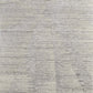Textured close-up of a 9' X 13' Ivory And Gray Abstract Hand Knotted Distressed Area Rug, showcasing its premium fibers.