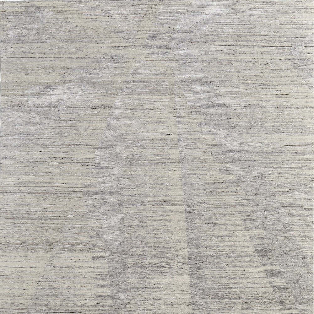 Textured close-up of a 9' X 13' Ivory And Gray Abstract Hand Knotted Distressed Area Rug, showcasing its premium fibers.