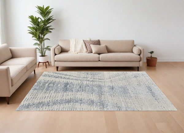 Ivory Gray and Blue Abstract Hand Knotted Worn Faded Area Rug | 9' x 13' in a modern living room setting.