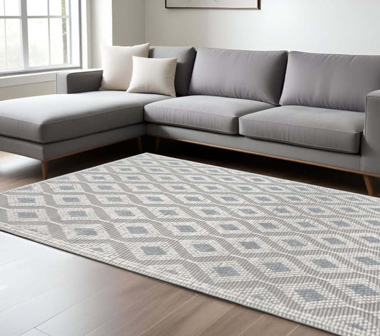 Ivory Gray Diamond Trellis Modern Area Rug | 9' x 13' placed in a contemporary living room with a gray sectional sofa.