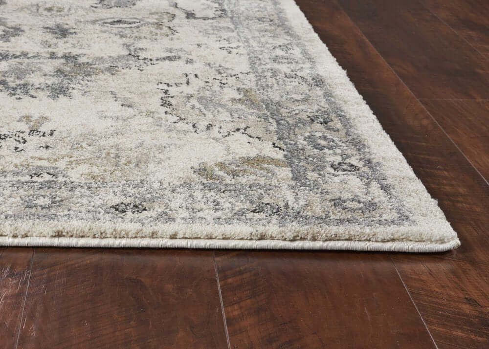 Ivory And Gray Floral Medallion Distressed Area Rug | 9' x 13' corner detail on hardwood floor