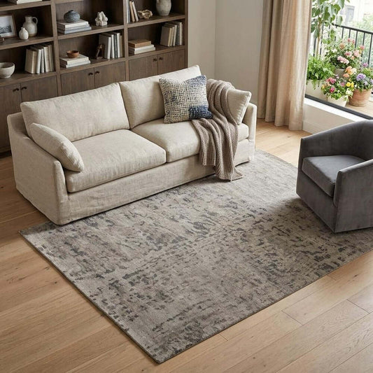Ivory And Gray Wool Abstract Hand Knotted Area Rug | 9' x 13' placed under light-colored sofa in a cozy living room.
