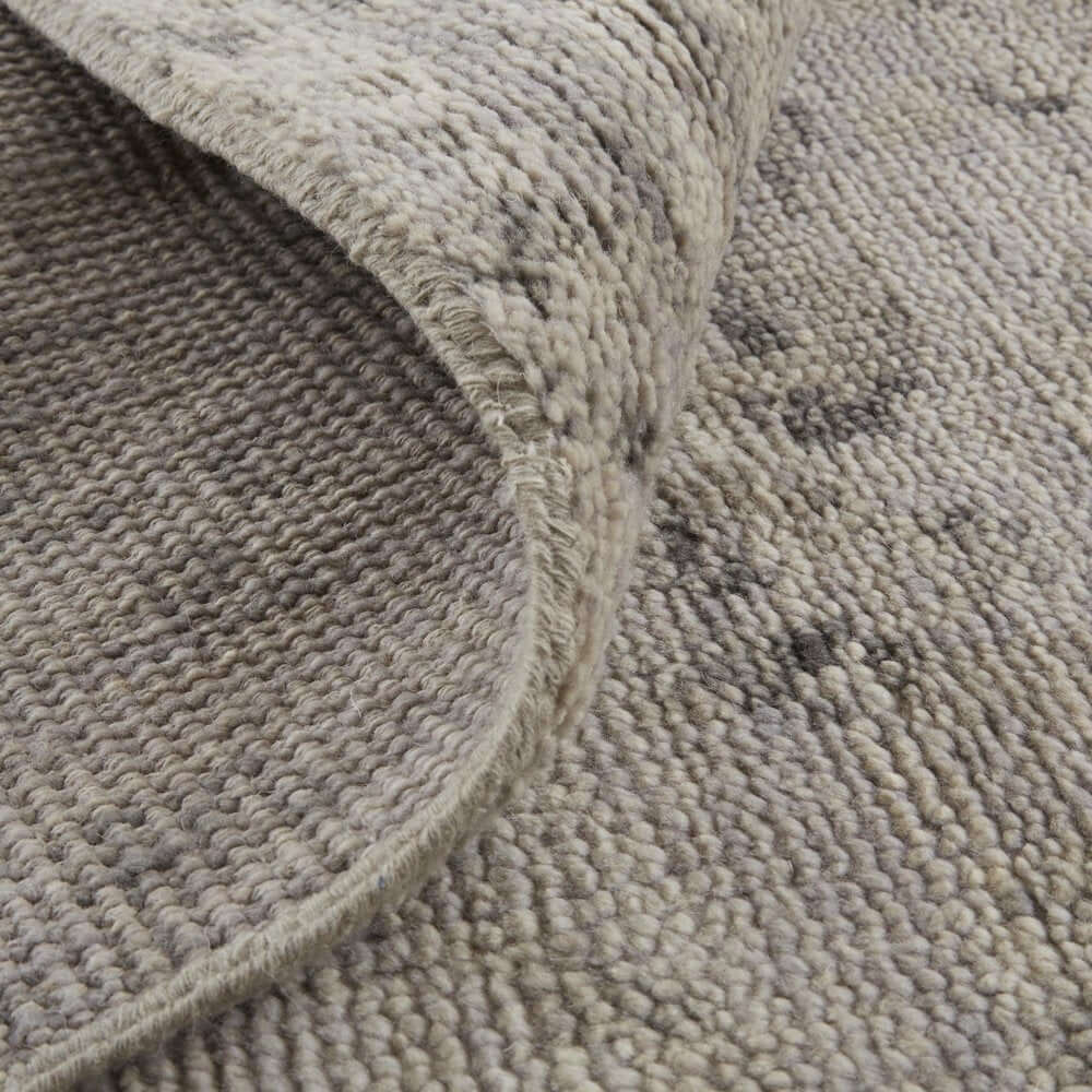 Ivory And Gray Wool Abstract Hand Knotted Area Rug | 9' x 13' with a textured surface and rolled edge.