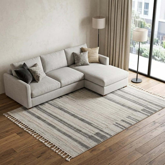 Ivory Grey Machine Woven Abstract Color Block Indoor Area Rug | 9' x 13' under a modern sofa in a cozy living room.