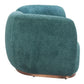 Curved sofa in soft teal shearling-style fabric with a sleek brass base, showcasing modern design and cozy comfort.