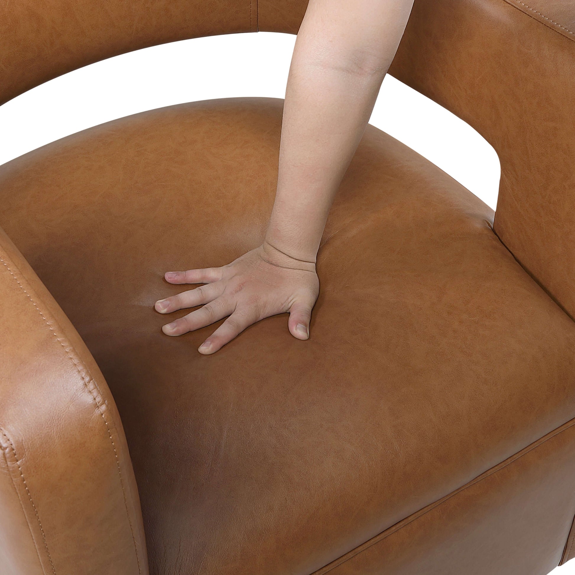 MCM Faux Leather Swivel Chair – Modern Barrel Accent Chair (2 Colors) featuring a hand pressing on the camel-tone faux leather seat.