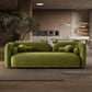Minimalist Curved Boucle Sofa 93” – Donna Modern Sculptural Couch (3 Colors) in green fabric, set in a contemporary living space.