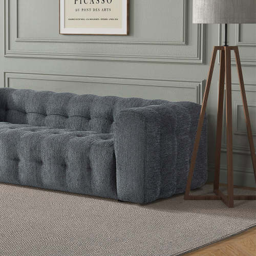 A modern living room with the Ashcroft Furniture Eden Modern Boucle Bubble Sofa 90, premium boucle upholstery, a gray textured rug, wooden floor lamp with gray shade, and a framed Picasso print on a light gray paneled wall.