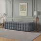 A modern glam living room featuring the Ashcroft Furniture Eden Modern Boucle Bubble Sofa 90, a gray tripod floor lamp, a framed Picasso print on green paneling, a small side table, and a textured gray rug on wood floors.