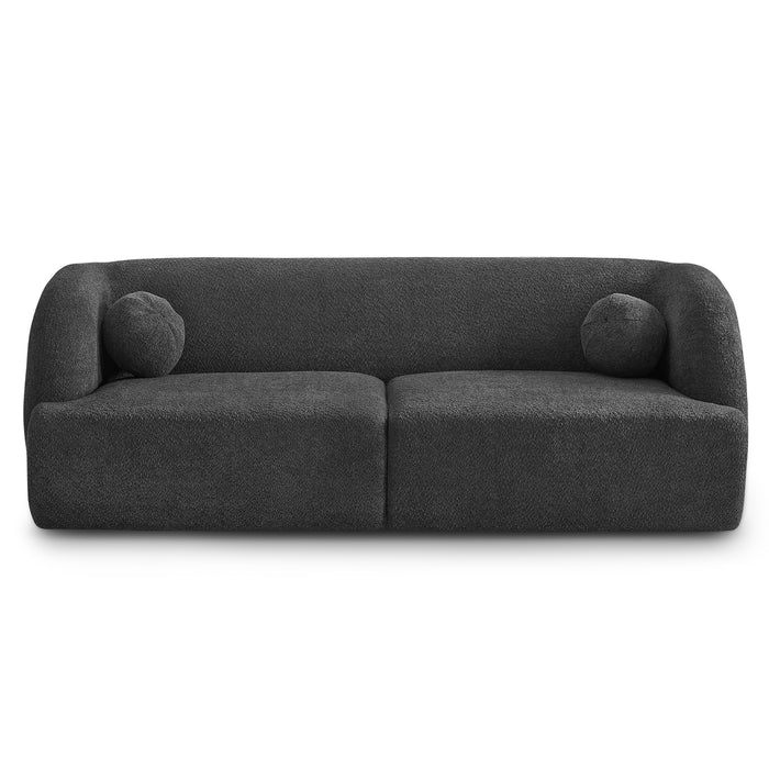 The Anna Boucle Fabric Upholstered Sofa by Ashcroft Furniture features a modern dark gray design with a rounded back and arms, plus two matching round cushions for minimalist elegance. Available in 87 size and four color options.