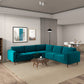 A modern living room features the Ashcroft Furniture Amber MCM Corner Sectional Sofa 103 in teal, arranged in an L-shape with a round wooden coffee table and neutral walls. Two framed artworks hang above, a floor lamp is in the corner, and a dining area is visible beyond.
