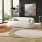 Modern Curved Boucle Sofa 84” (3 Colors) – Andrew Minimalist Sculptural Couch in a stylish living room setting.