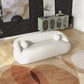 Modern Curved Boucle Sofa 84” (3 Colors) – Andrew Minimalist Sculptural Couch in a stylish living room setting.