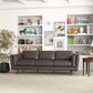 A modern living room featuring the Ashcroft Furniture Chase MCM Genuine Leather Sofa 91 in dark brown, a large leafy plant, a side table with a lamp, and built-in shelves with books and decor against a white wall.