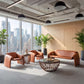 Horten Industrial Loveseat – 70” Modern Sofa with Steel Frame in a stylish office setting with large windows and city views.
